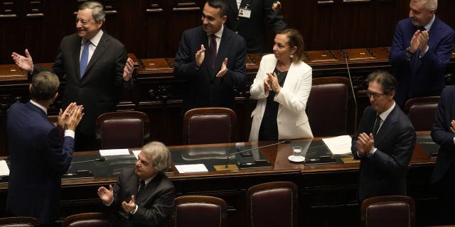 Italian Premier Mario Draghi, top left, leaves at the end of his address at the Parliament in Rome, Thursday, July 21, 2022.
