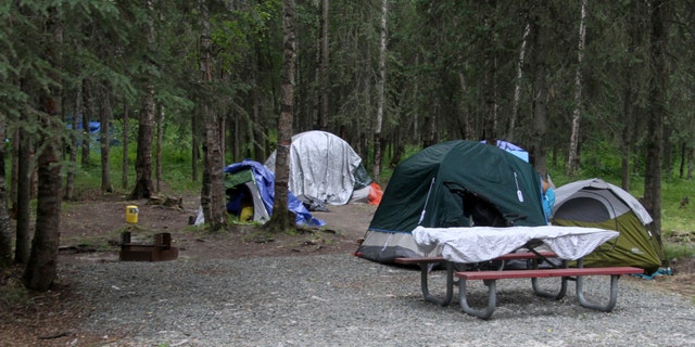 An Anchorage police officer and a man were wounded in a shootout at the city-owned campground that has been turned into an outdoor shelter for homeless people. Pictured: Tents are shown inside Centennial Park, a campground recently set aside for the city's homeless population, in Anchorage, Alaska.