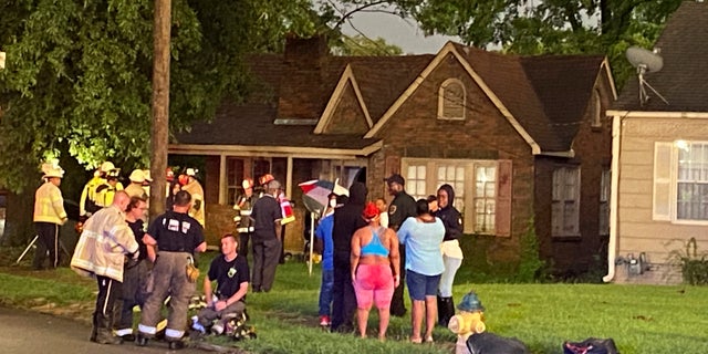 Birmingham Fire and Rescue Service respond to a home after a tree fell during a storm in Birmingham, Ala. Battalion Chief Sebastian Carrillo said they arrived to find the massive tree had smashed into the brick home.