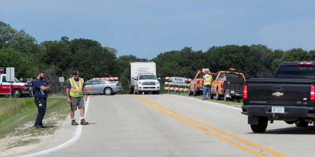 Emergency personnel block an entrance to the Maquoketa Caves State Park as police investigate a shooting that left several people dead, Friday, July 22, 2022, in Maquoketa. Iowa. 