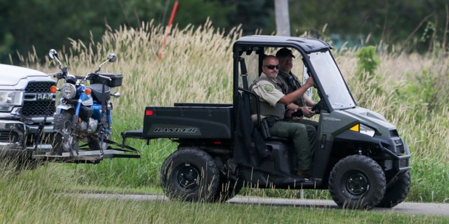 An entrance to the Maquoketa Caves State Park is blocked as police investigate a deadly shooting on Friday, July 22, 2022, in Maquoketa, Iowa. 