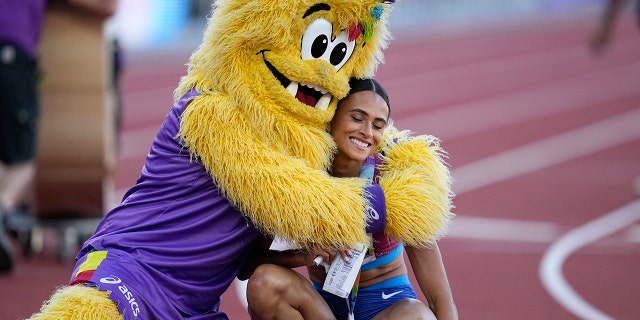 Gold medalist Sydney McLaughlin, of the United States, is embraced after winning the final of the women's 400-meter hurdles at the World Athletics Championships on Friday, July 22, 2022, in Eugene, Ore.