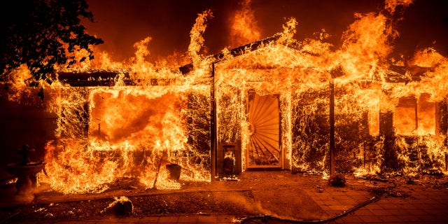 Flames consume a home on Triangle Road as the Oak Fire burns in Mariposa County, California, on Saturday, July 23, 2022.