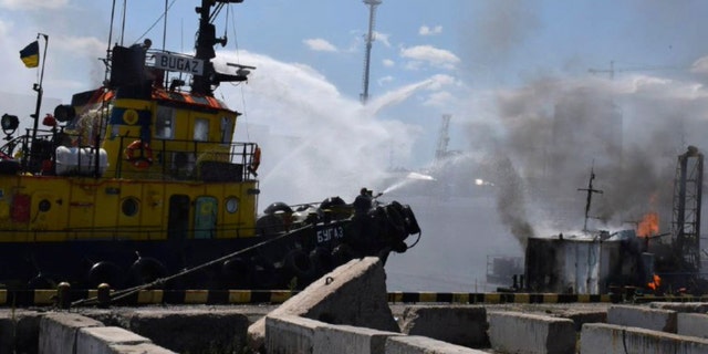 In this photo provided by the press service of the Odessa City Hall, firefighters put out a fire in the port after a Russian rocket attack on Odessa, Ukraine, June 5, 2022.  Russian missiles hit the Ukrainian Black Sea port of Odessa just hours after Moscow.  and Kyiv signed agreements allowing the resumption of grain exports from there.