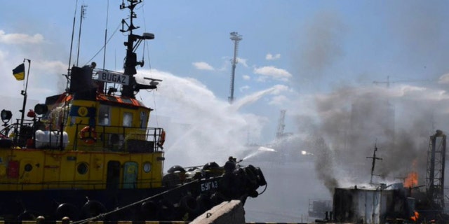 In this photo provided by the Odesa City Hall Press Office, firefighters put out a fire in the port after a Russian missile attack in Odesa, Ukraine, on June 5, 2022. Russian missiles have struck Ukraine’s Black Sea port of Odesa just hours after Moscow and Kyiv signed deals to allow grain exports to resume from there.