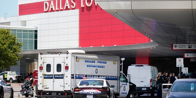 A crime scene response vehicle arrives at Dallas Love Field in Dallas, Monday, July 25, 2022, after a woman allegedly opened fire by a ticketing counter inside. 