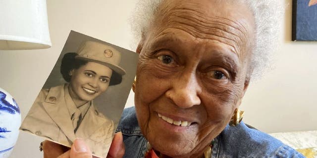 Romay Davis, 102, poses with her World War II portrait. She served in the 6888th Central Postal Directory Battalion.