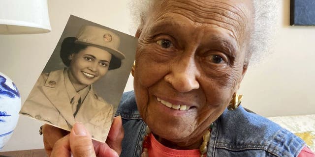 Romay Davis, 102, poses with her World War II portrait. She served in the 6888th Central Postal Directory Battalion.