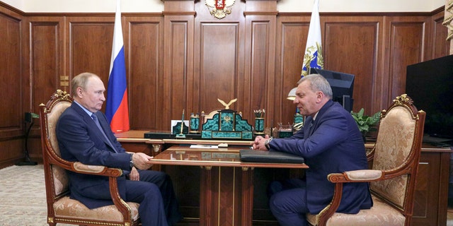 Russian President Vladimir Putin, left, listens to Yuri Borisov, the new CEO of the Russian State Space Corporation "Roscosmos", at the Kremlin in Moscow, Russia, Tuesday, July 26, 2022. 