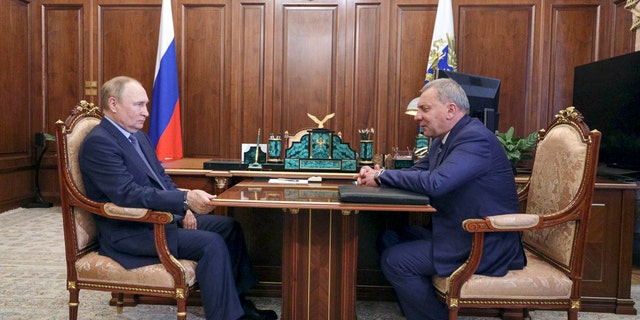 Russian President Vladimir Putin, left, listens to Yuri Borisov, the new CEO of the Russian State Space Corporation "Roscosmos", at the Kremlin in Moscow, Russia, Tuesday, July 26, 2022.