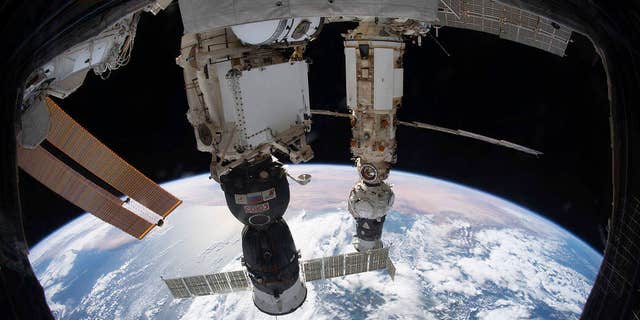File photo provided by NASA on December 6, 2021 shows the International Space Station orbiting 264 miles above the Tyrrhenian Sea, the Soyuz MS-19 crew ship docked with the Rusvett module, and the Pricial module continuing with the Progress carrier. is attached to the  , docked to the Nauka multipurpose module. 