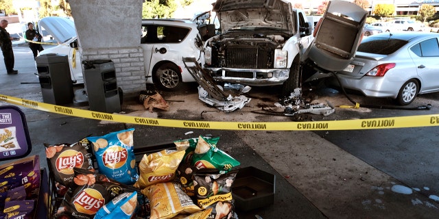 Police investigate a car accident at a gas station in the Panorama City section of Los Angeles on Tuesday, July 26, 2022.