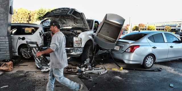 Police investigate a car accident at a gas station in the Panorama City section of Los Angeles on Tuesday, July 26, 2022. 