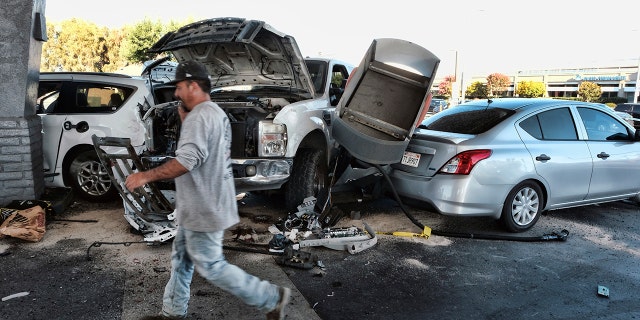 Police investigate a car accident at a gas station in the Panorama City section of Los Angeles on Tuesday, July 26, 2022.