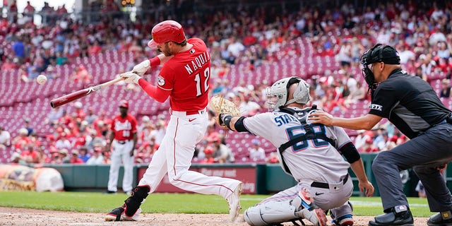 The Cincinnati Reds' Tyler Naquin (12) hits a solo home run during the sixth inning of a game against the Miami Marlins Thursday, July 28, 2022, in Cincinnati. 