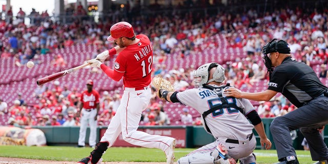 The Cincinnati Reds' Tyler Naquin (12) hits a solo home run during the sixth inning of a game against the Miami Marlins Thursday, July 28, 2022, in Cincinnati.