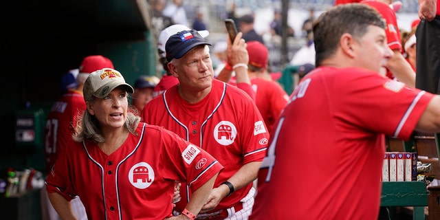 Sen. Joni Ernst, R-Iowa, left, and Rep. Pete Sessions, R-Texas, stand in the dugout before the Congressional Baseball Game on Thursday, July 28, 2022, in Washington. The annual game between Congressional Republicans and Democrats raises money for charity. 