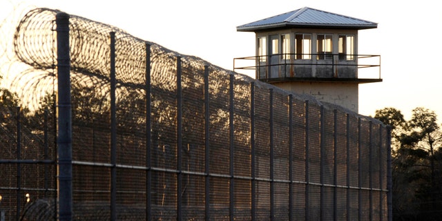 The sun sets behind Holman Prison in Atmore, Alabama, on Jan. 27, 2022.