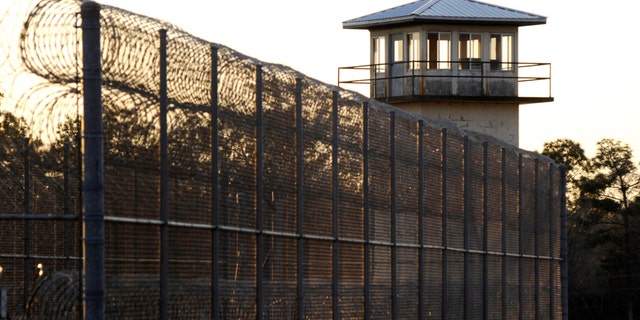 The sun sets behind Holman Prison in Atmore, Alabama, on Jan. 27, 2022.