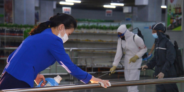 In this photo published on June 28, 2022 by the North Korean government, North Korean employees disinfect a facility at an underground store in Pyongyang, North Korea.