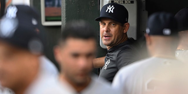 New York Yankees manager Aaron Boone stands in the dugout during the team's game against the Baltimore Orioles on Saturday, July 23, 2022 in Baltimore.  The Orioles won 6-3.