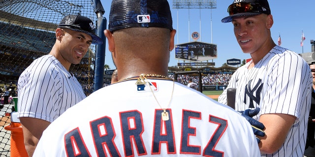 American League All-Stars Giancarlo Stanton #27 (L) and Aaron Judge #99 of the New York Yankees (R) talk with Luis Arraez #2 of the Minnesota Twins during the 2022 Gatorade All-Star Workout Day at Dodger Stadium on July 18, 2022 in Los Angeles, California.