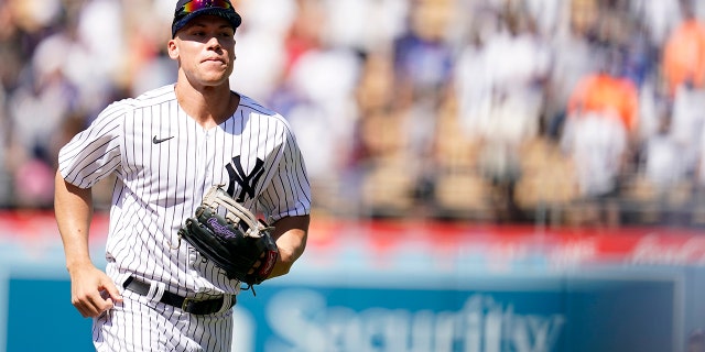 New York Yankees Aaron Judge, left, runs in the outfield during batting practice a day before the 2022 MLB All-Star baseball game, Monday, July 18, 2022, in Los Angeles.