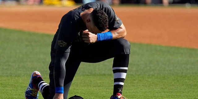 American League's Aaron Judge, of the New York Yankees, kneels on the field before the start of the MLB All-Star baseball game against the National League, Tuesday, July 19, 2022, in Los Angeles.