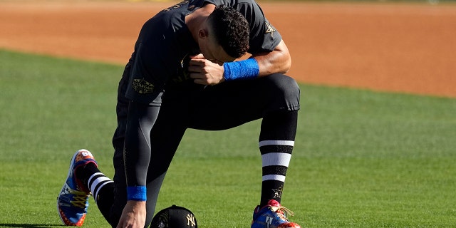 American League's Aaron Judge, of the New York Yankees, kneels on the field before the start of the MLB All-Star baseball game against the National League, Tuesday, July 19, 2022, in Los Angeles.