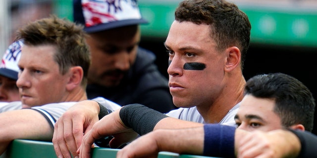 Aaron Judge of New York Yankees, second from right, stands in the dugout during the second inning of the team's baseball game against the Pittsburgh Pirates in Pittsburgh, Tuesday, July 5, 2022. The Pirates won 5-2. 