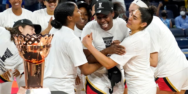 Las Vegas Aces' Chelsea Gray, center, is mobbed by her teammates as she is named MVP of the WNBA Commissioner's Cup basketball game against the Chicago Sky Tuesday, July 26, 2022, in Chicago. The Aces won 93-83.