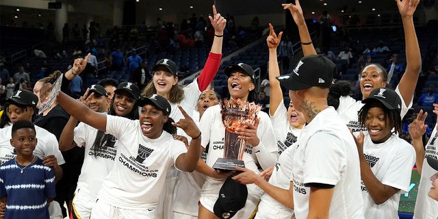 The Las Vegas Aces celebrate with the Commissioner's Cup after defeating the Chicago Sky 93-83 in the WNBA Commissioner's Cup basketball game Tuesday, July 26, 2022, in Chicago. 