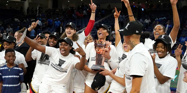The Las Vegas Aces celebrate with the Commissioner's Cup after defeating the Chicago Sky 93-83 in the WNBA Commissioner's Cup basketball game Tuesday, July 26, 2022, in Chicago.