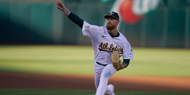 Oakland Athletics' Adam Oller pitches against the Houston Astros during the first inning of a baseball game in Oakland, Calif., Monday, July 25, 2022.