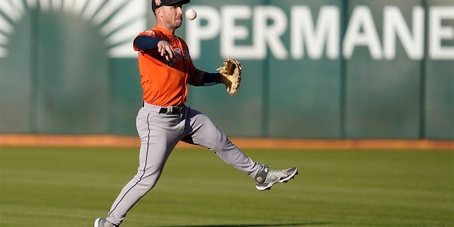 Houston Astros third baseman Alex Bregman throws out Oakland Athletics' Vimael Machin at first base during the first inning of a baseball game in Oakland, Calif., Monday, July 25, 2022.