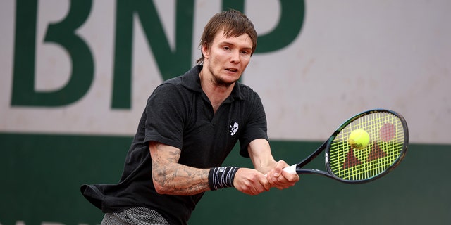 Alexander Bublik of Kazakhstan plays a backhand against Arthur Rinderknech of France during the Men's Singles First Round match on Day 3 of the French Open at Roland Garros on May 24, 2022 in Paris, France.