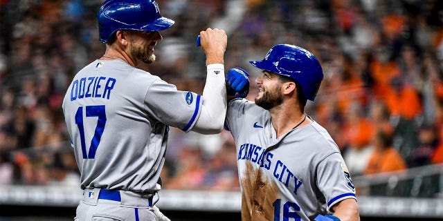 Hunter Dozier #17 of the Kansas City Royals celebrates his two-run home run with Andrew Benintendi #16 against the Houston Astros in the first inning at Minute Maid Park on July 06, 2022 in Houston, Texas.