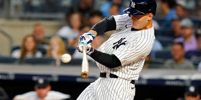 New York Yankees' Anthony Rizzo hits a two-run single during the first inning of the team's baseball game against the Cincinnati Reds on Tuesday, July 12, 2022, in New York.