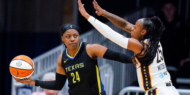 Dallas Wings guard Eric Ogunbowale (24) catches Indiana Fever guard Tiffany Mitchell (25) during the first half of a WNBA basketball game in Indianapolis, Sunday, July 24, 2022. 