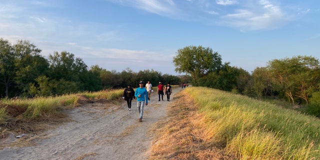 People who crossed the U.S.-Mexico border illegally search for Border Patrol in La Joya, Texas.