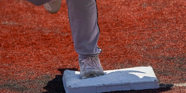 Larger bases are installed on the infield during a minor league baseball game between the Brooklyn Cyclones and Greensboro Grasshoppers, Wednesday, July 13, 2022, in the Coney Island neighborhood of the Brooklyn borough of New York. Major League Baseball is considering a pitch clock for next year along with shift limits, larger bases and restrictions on pickoff attempts.  