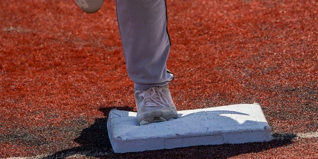 Larger bases are installed on the infield during a minor league baseball game between the Brooklyn Cyclones and Greensboro Grasshoppers, Wednesday, July 13, 2022, in the Coney Island neighborhood of the Brooklyn borough of New York. Major League Baseball is considering a pitch clock for next year along with shift limits, larger bases and restrictions on pickoff attempts.