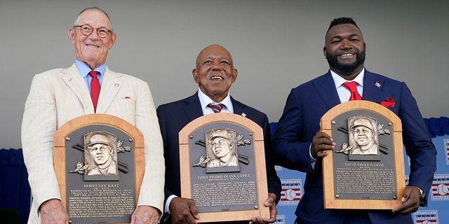 From left to right, National Baseball Hall of Fame inductees Jim Kaat, Tony Oliva and David Ortiz hold their plaques during the Hall of Fame induction ceremony, Sunday, July 24, 2022, at the Clark Sports Center in Cooperstown, N.Y.