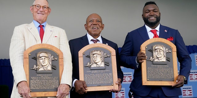 From left to right, National Baseball Hall of Fame inductees Jim Kaat, Tony Oliva and David Ortiz hold their plaques during the Hall of Fame induction ceremony, Sunday, July 24, 2022, at the Clark Sports Center in Cooperstown, N.Y.