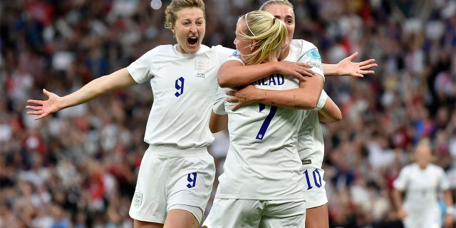 England's Beth Mead, center, celebrates with Ellen White, left, and Georgia Stanway after scoring the opening goal during the Women Euro 2022 soccer match between England and Austria at Old Trafford in Manchester, England, Wednesday, July 6, 2022.