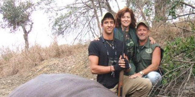 A photo of Bianca and Lawrence Rudolph with their grown son on a hunting trip. Lawrence Rudolph is on trial for murdering his wife on a trip to Zambia, so he could be with his mistress.