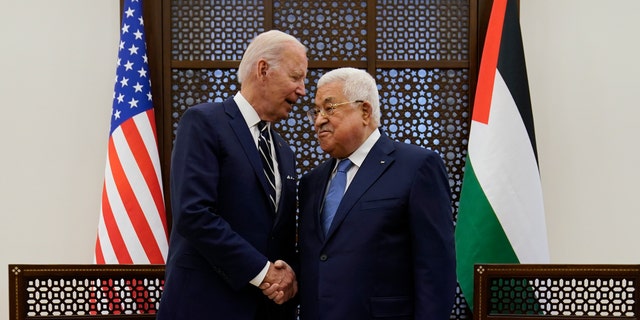 Palestinian President Mahmoud Abbas and U.S. President Joe Biden shake hands in the West Bank town of Bethlehem, Friday, July 15, 2022.