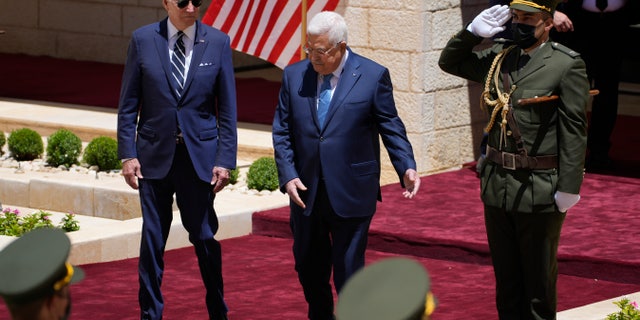 U.S. President Joe Biden and Palestinian President Mahmoud Abbas review the guard of honor during a welcoming ceremony prior to their meeting at the West Bank town of Bethlehem, Friday, July 15, 2022. (AP Photo/Majdi Mohammed)