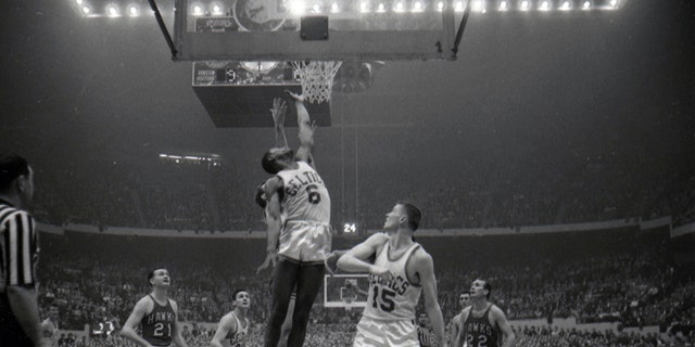 The Boston Celtics' Bill Russell rebounds vs the St. Louis Hawks at Boston Garden in Boston, Massachusetts.
