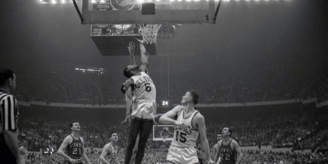 Boston Celtics Bill Russell (6) rebounds vs. the St. Louis Hawks at Boston Garden in Boston, Massachusetts.